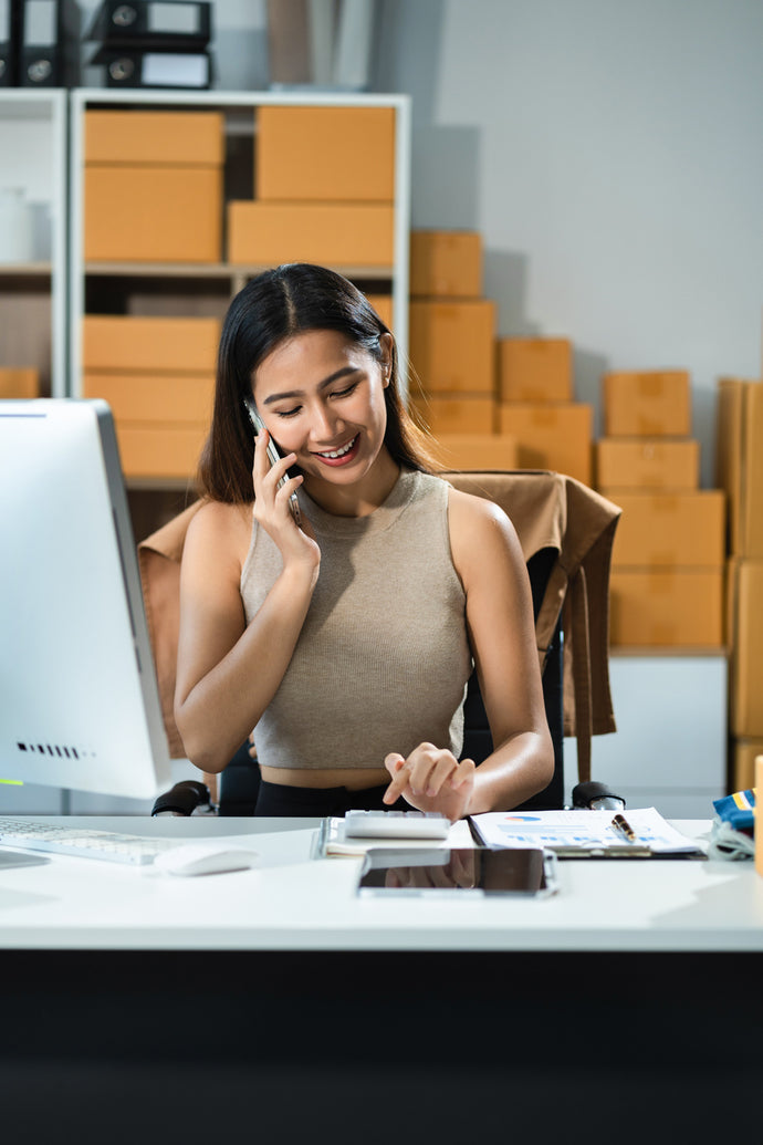 Photo of Small Business Account Manager With Boxes In The Background