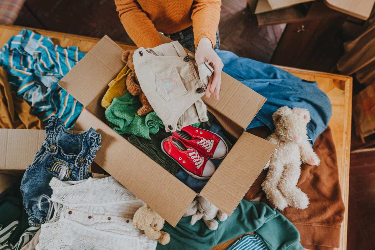 Photo of Packing Kids Clothes Into Moving Box
