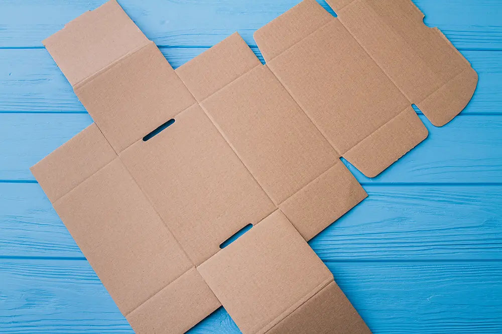 Flat cardboard box on a blue wooden surface