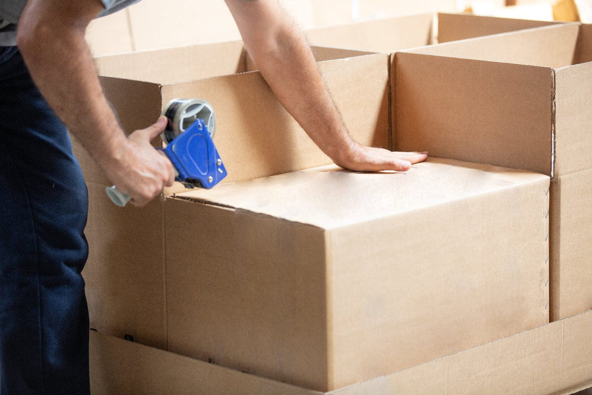 Photo of Sealing A Moving Box With Tape