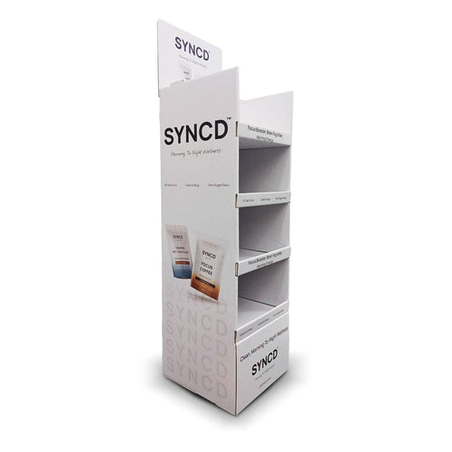 SYNCD display stand with product packaging on a white background