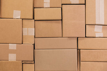 Photo of Cardboard Boxes Stacked Together in Tetris Pattern