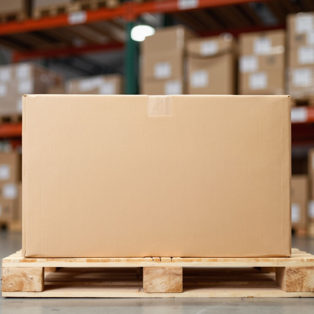 Cardboard box on a wooden pallet in a warehouse setting